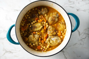 Adding chick peas to a chicken stew.