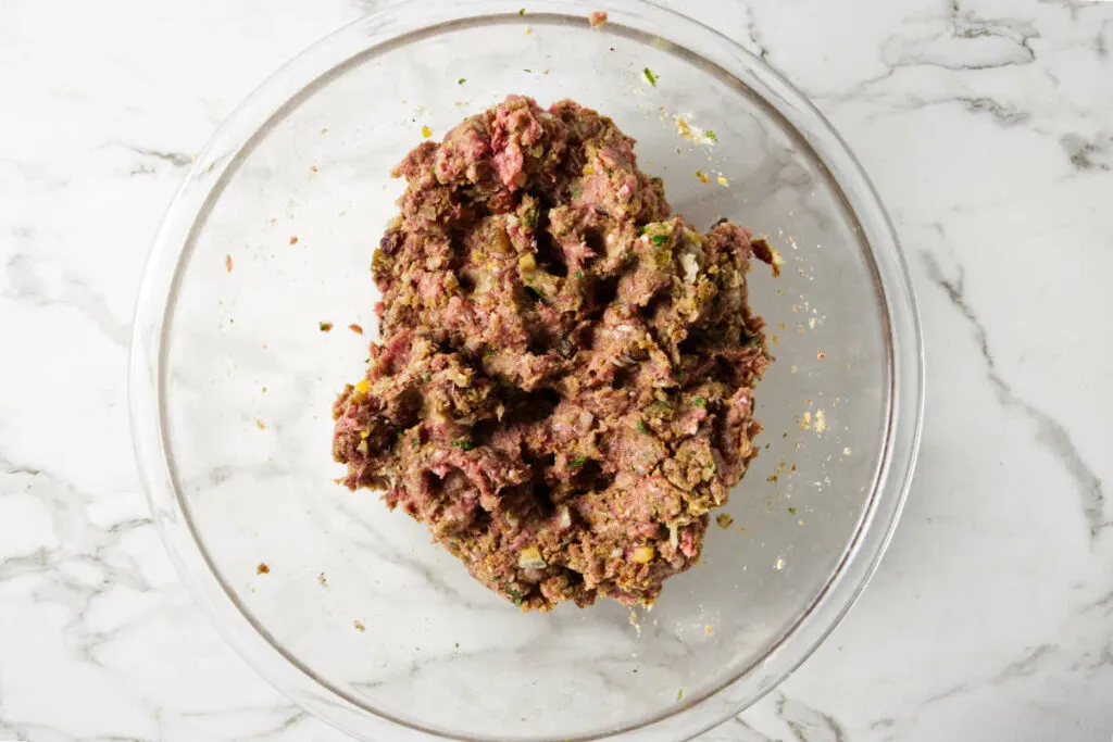 Combining ground lamb with spices, mint, preserved lemon, and raisins.