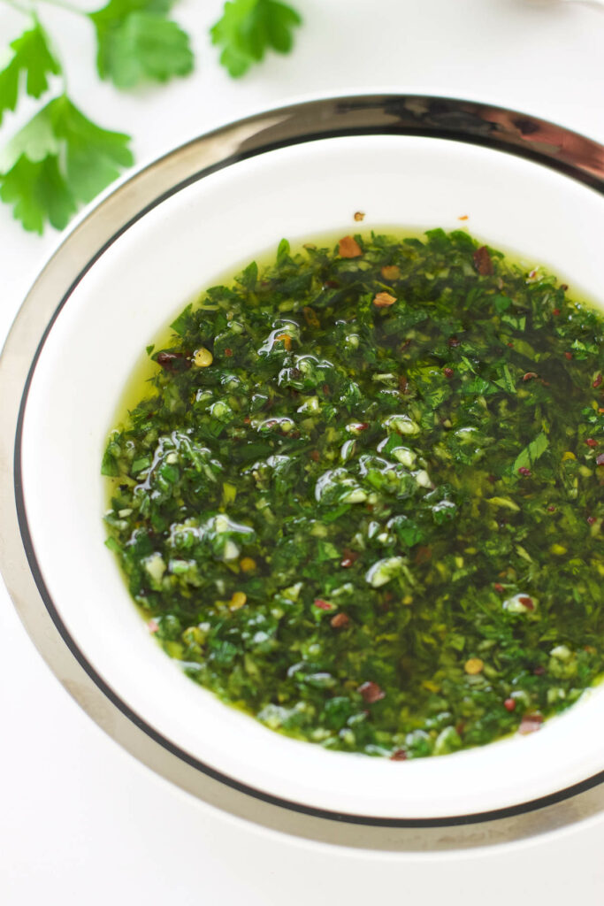 Chimichurri sauce ready to serve with a steak.