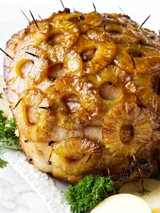 A smoked ham with pineapple rings and glaze.