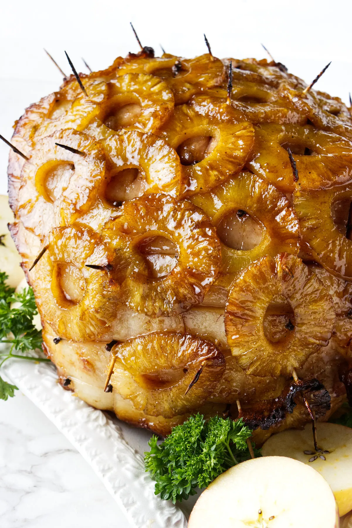A smoked ham with pineapple rings and glaze.