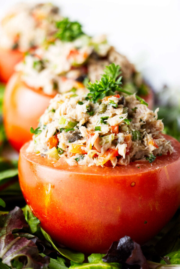 Three tomatoes filled with healthy tuna salad.