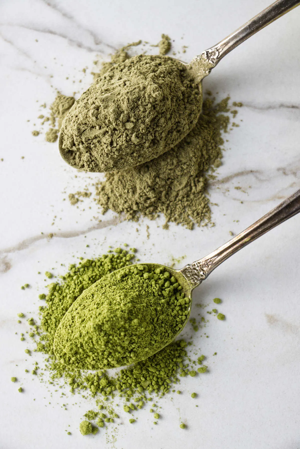 Muddy green matcha powder next to a vibrant green matcha powder.