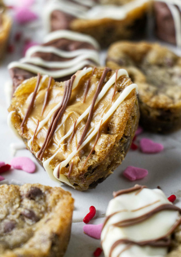 Several chocolate chip cookies shaped like hearts.