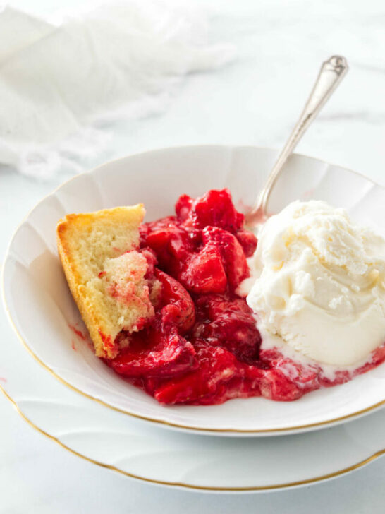 A bowl filled with a serving of strawberry spoon cake.