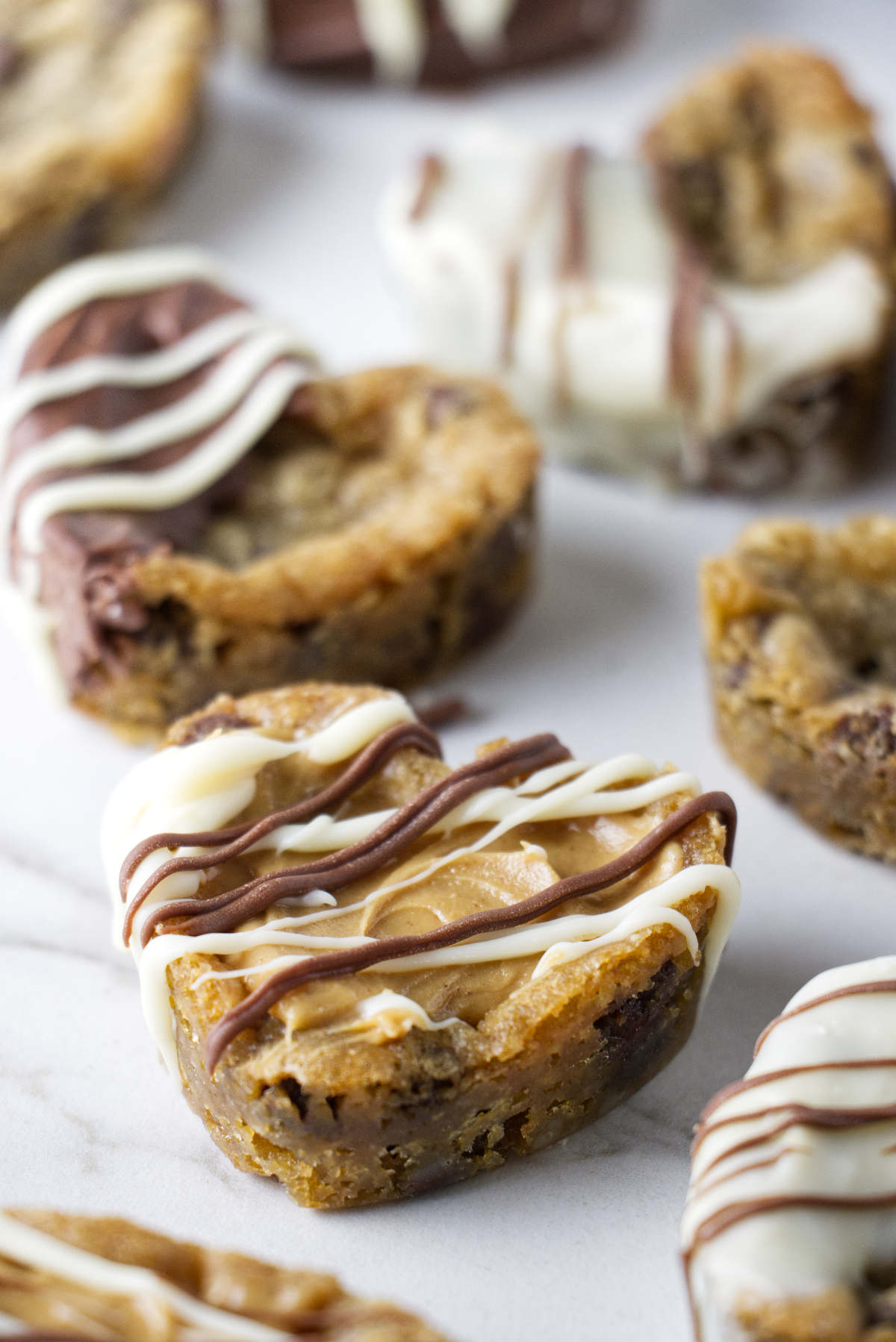 Chocolate chip cookies shaped like hearts and filled with dulce de leche.