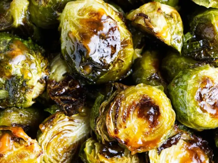 Glazed sriracha Brussel sprouts with char marks.