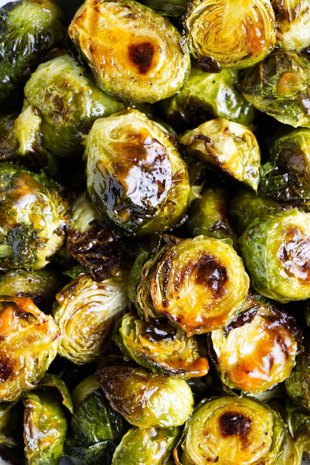Glazed sriracha Brussel sprouts with char marks.