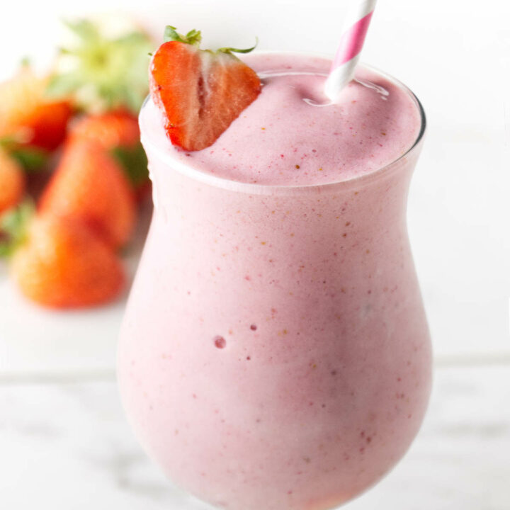 A strawberry protein smoothie in a glass.