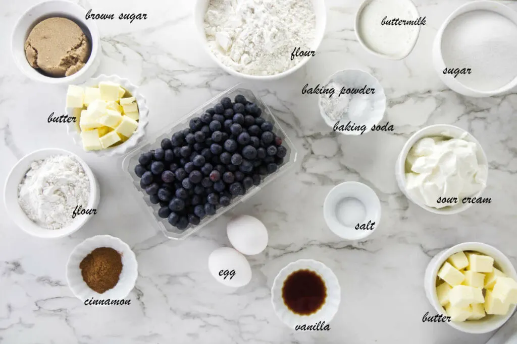 Blueberries, flour, buttermilk, sour cream, sugar, baking powder, baking soda, butter, salt, vanilla, and eggs.