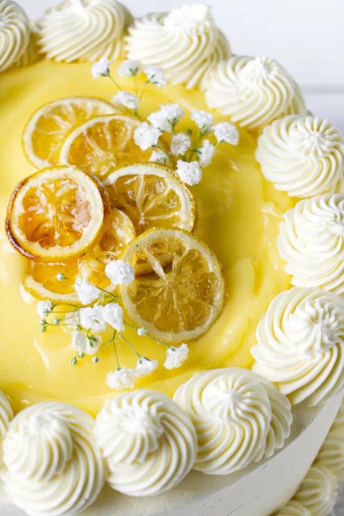 A white cake topped with buttercream and lemon curd.