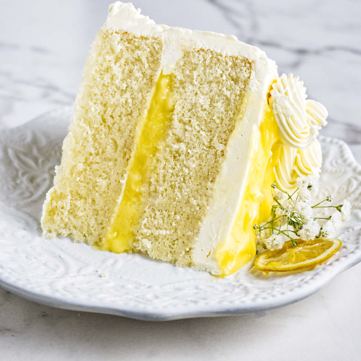 A slice of lemon curd cake on a plate.