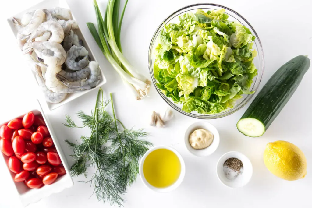 Lettuce, cucumber, lemon, salt, pepper, olive oil, garlic, dill, green onion, dijon mustard, shrimp, and tomatoes.