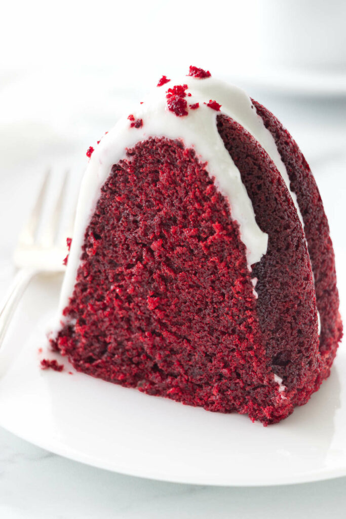 A slice of a red velvet bundt cake on a plate.