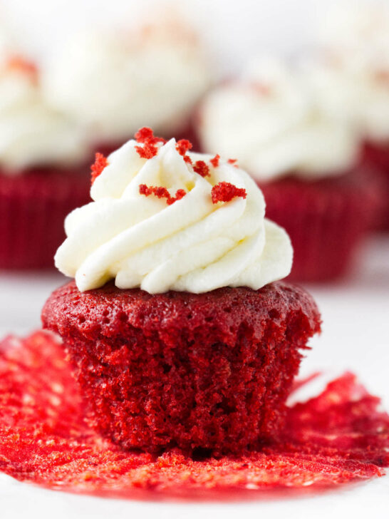 A red velvet mini cupcake with cream cheese frosting.
