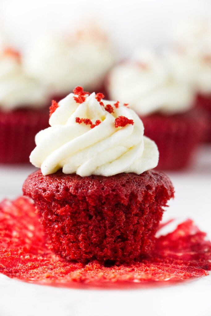 A red velvet mini cupcake with cream cheese frosting.