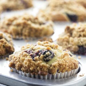 Freshly baked blueberry muffins in a muffin tin.