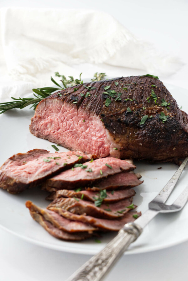 Slices of sous vide tri tip on a platter.