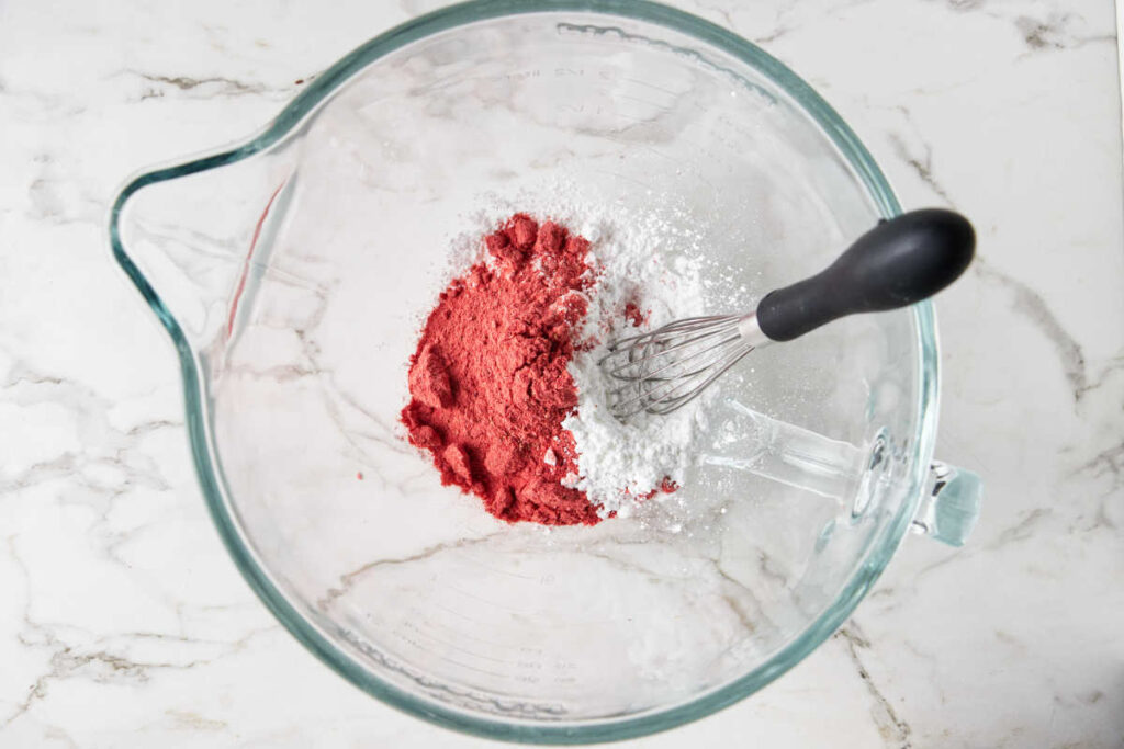 mixing strawberry powder with powdered sugar.