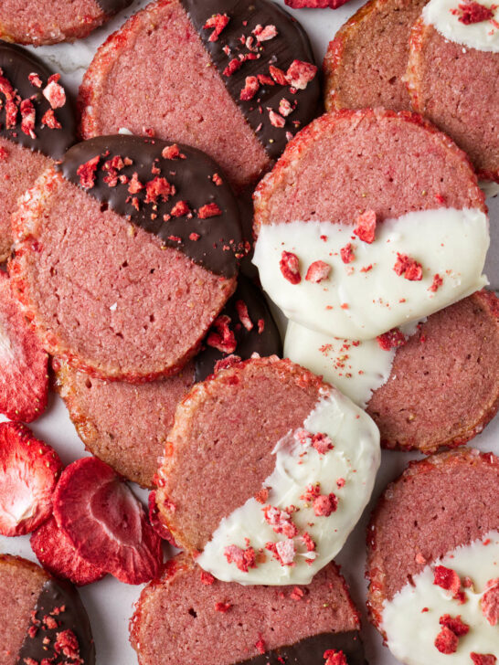 Round strawberry shortbread cookies dipped in dark and white chocolate.