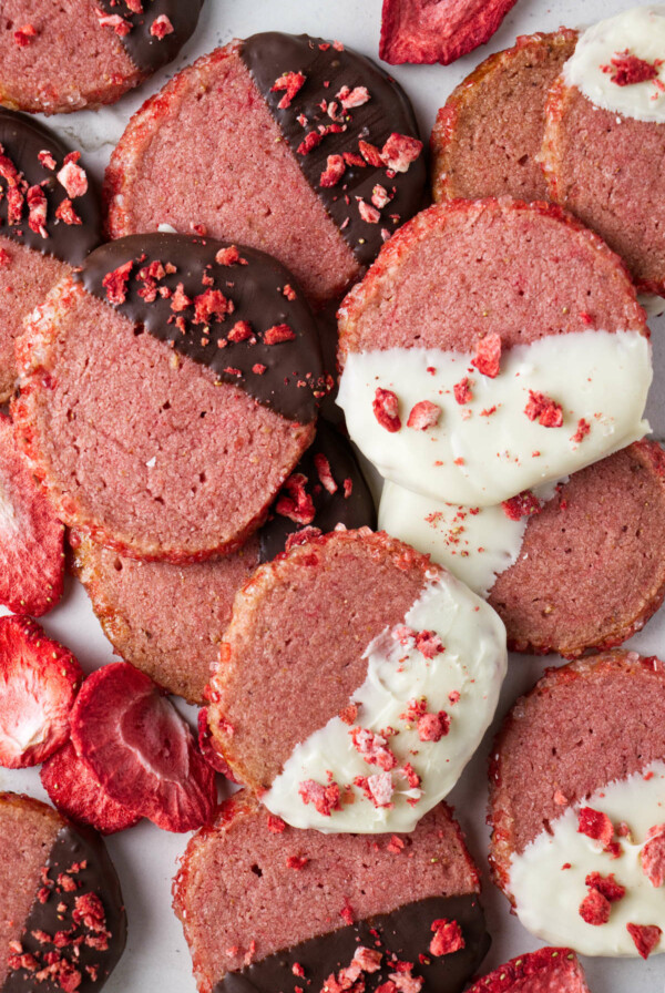 Round strawberry shortbread cookies dipped in dark and white chocolate.