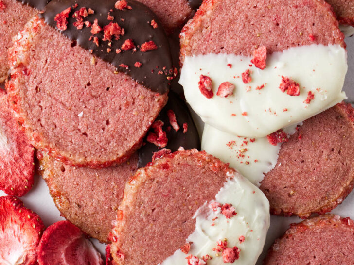 Round strawberry shortbread cookies dipped in dark and white chocolate.