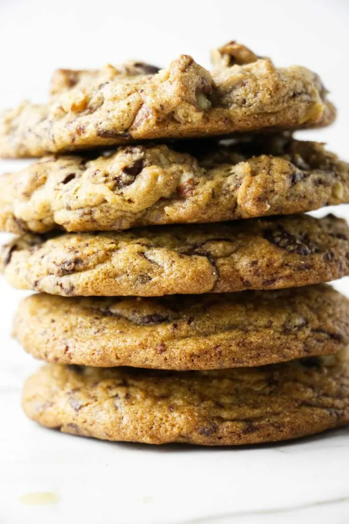 Five chocolate chip cookies stacked on top of each other.