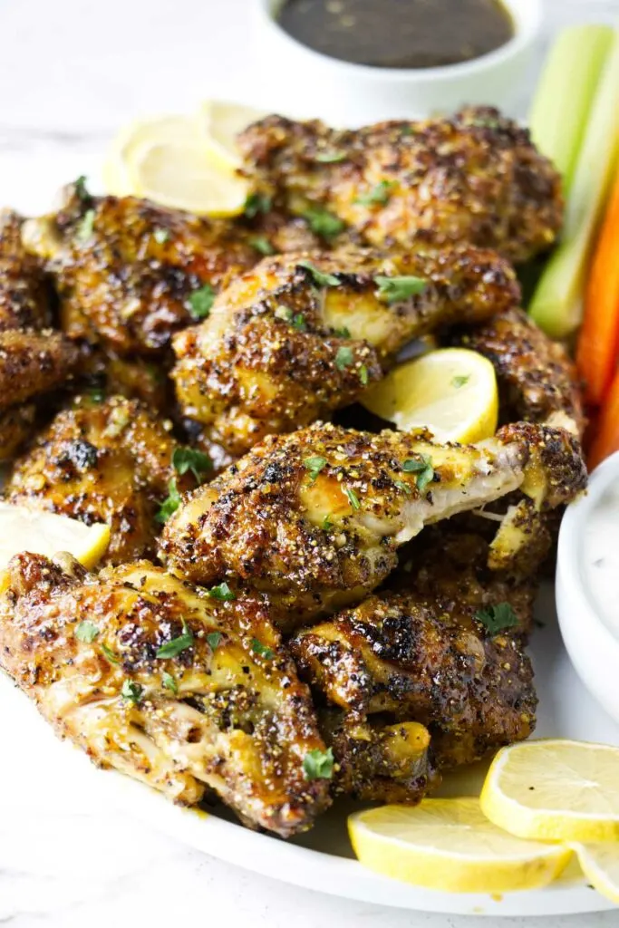 Several baked chicken wings on a plate.