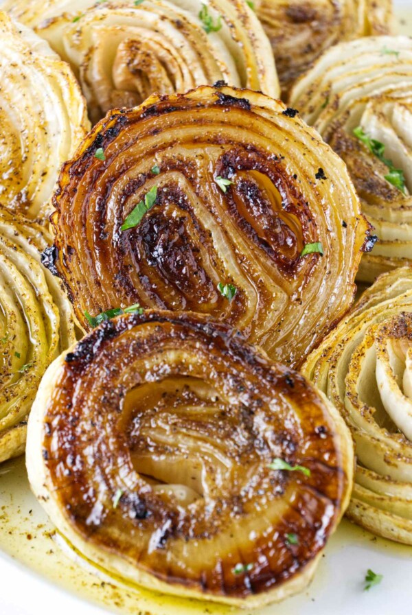 Golden brown slices of onions after being smoked on a pellet grill.