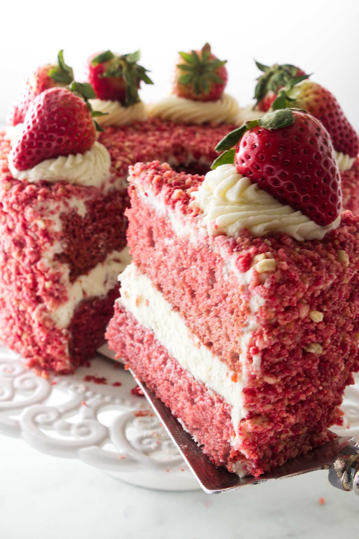 Serving a slice of strawberry cake.