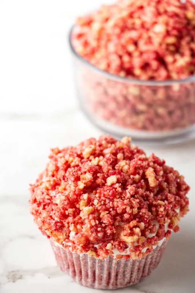 Strawberry crunch crumbs on a cupcake.