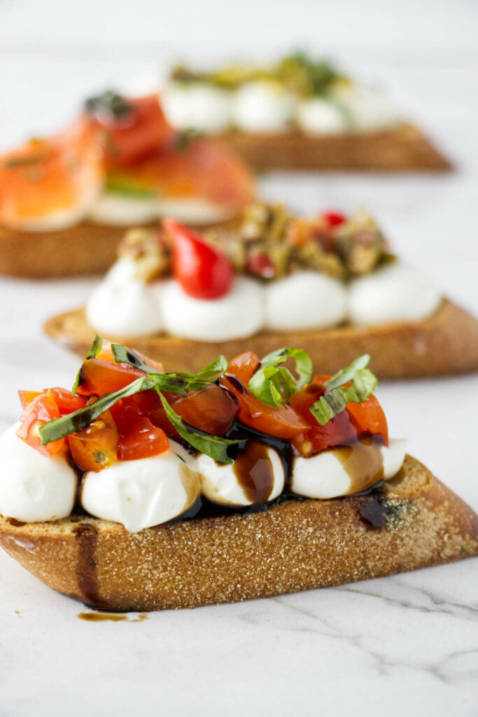 Tomatoes, basil, and whipped ricotta on a crostini with a drizzle of balsamic vinegar.