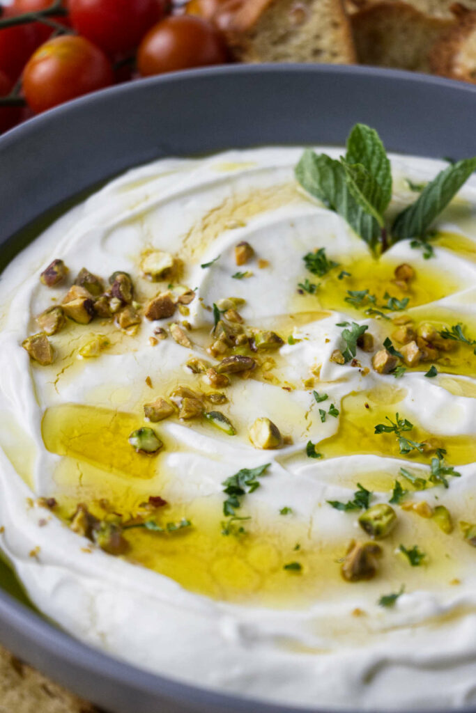 Ricotta dip in a bowl with olive oil and honey on top.