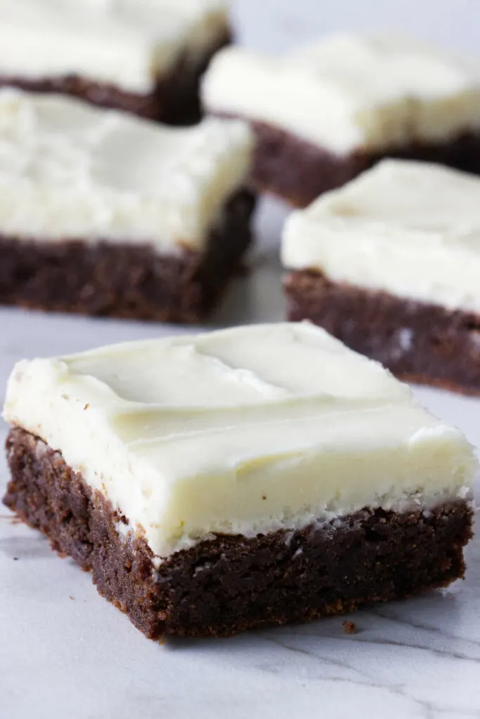 A brownie covered in cream cheese buttercream frosting.
