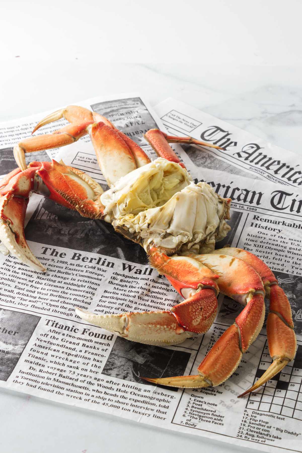 A cooked Dungeness crab on newspapers.