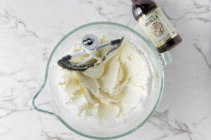Butter and powdered sugar mixed together. Vanilla extract next to the bowl.