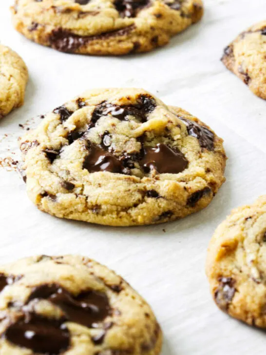 Chocolate chip cookies made with egg yolks on a baking sheet.