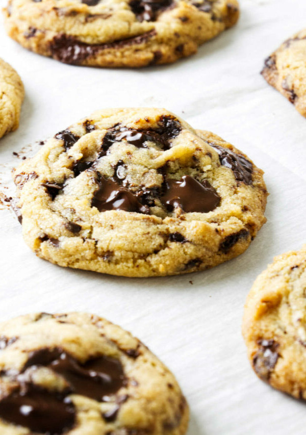 Chocolate chip cookies made with egg yolks on a baking sheet.