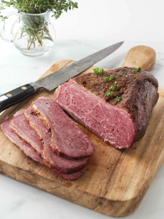 Slicing the corned beef on a cutting board.