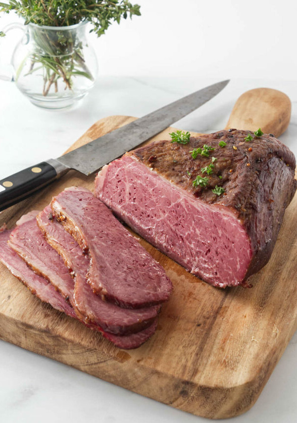 Slicing the corned beef on a cutting board.