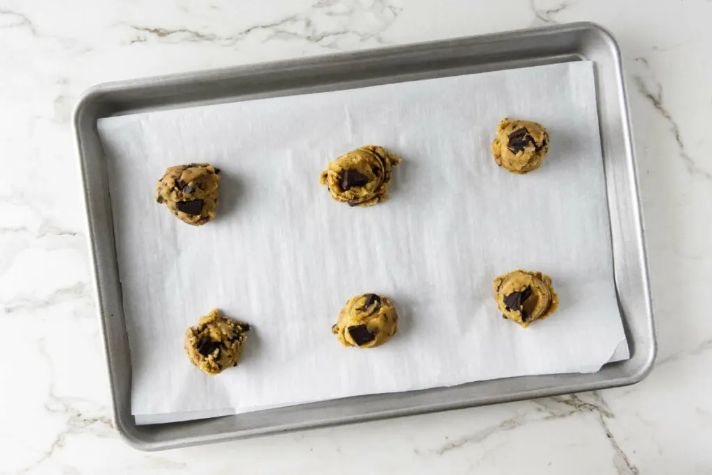 Placing cookie dough on a baking sheet.
