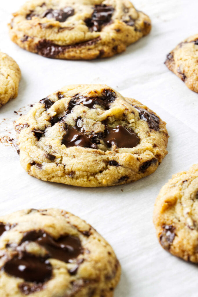 Chocolate chip cookies made with egg yolks on a baking sheet.