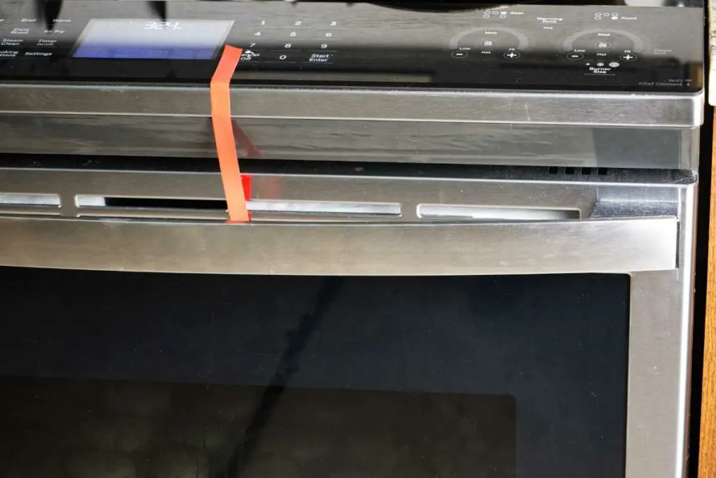 Sealing the oven door with tape.