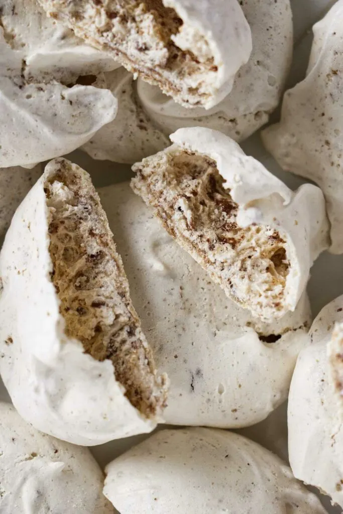 Meringue cookies split open to show a hollow shell.