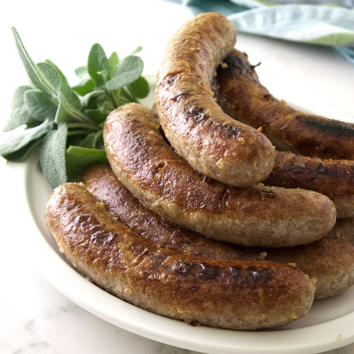 Beer simmered bratwurst on a plate.