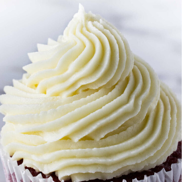 Cream cheese buttercream frosting swirled on top of a cupcake.