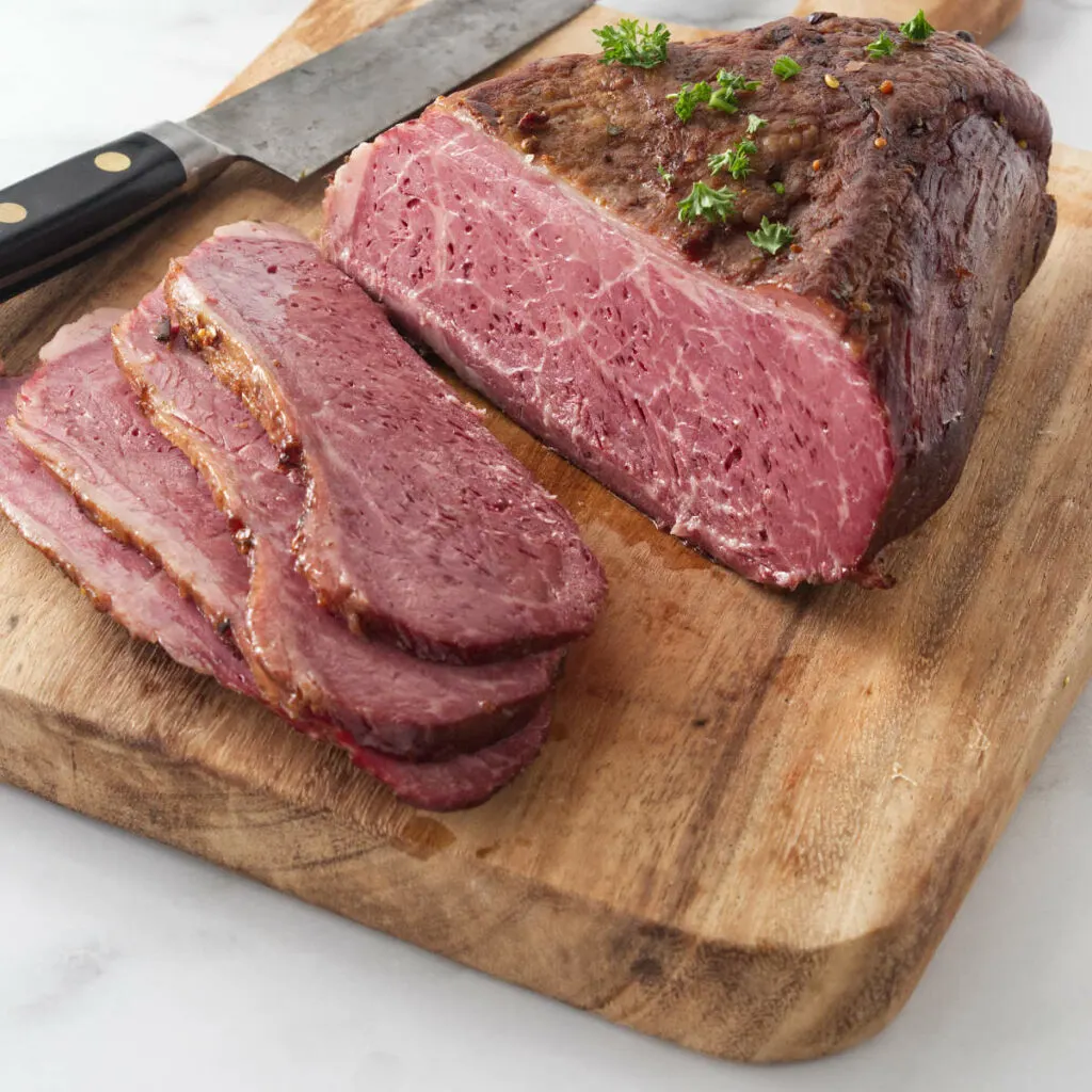 Close up photo of spis vide corned beef on a cutting board.