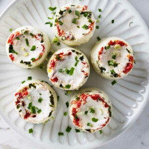 Sous vide egg white bites on a round plate.