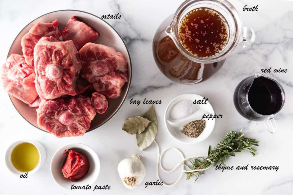 Oxtails, beef broth, wine, fresh herbs, salt, pepper, garlic, tomato paste, and oil.