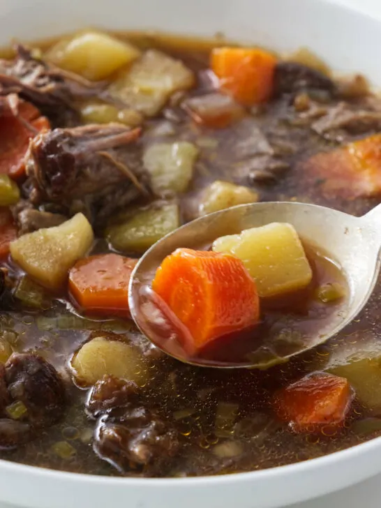 A spoonful of oxtail and vegetable soup.